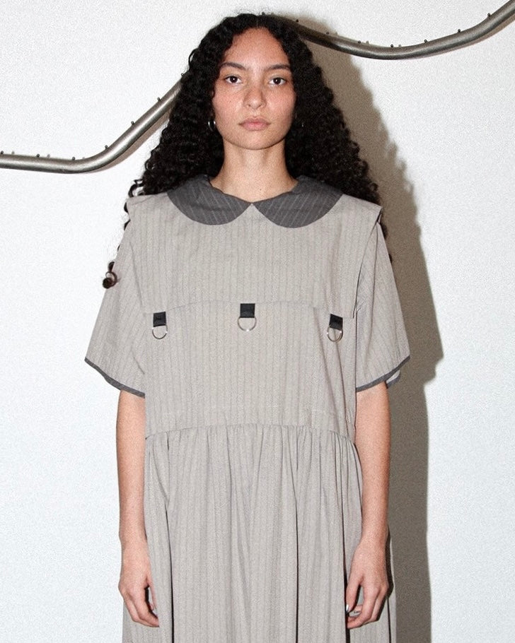 Front view of model wearing the Kkco grey pinstriped Pumice Dress
