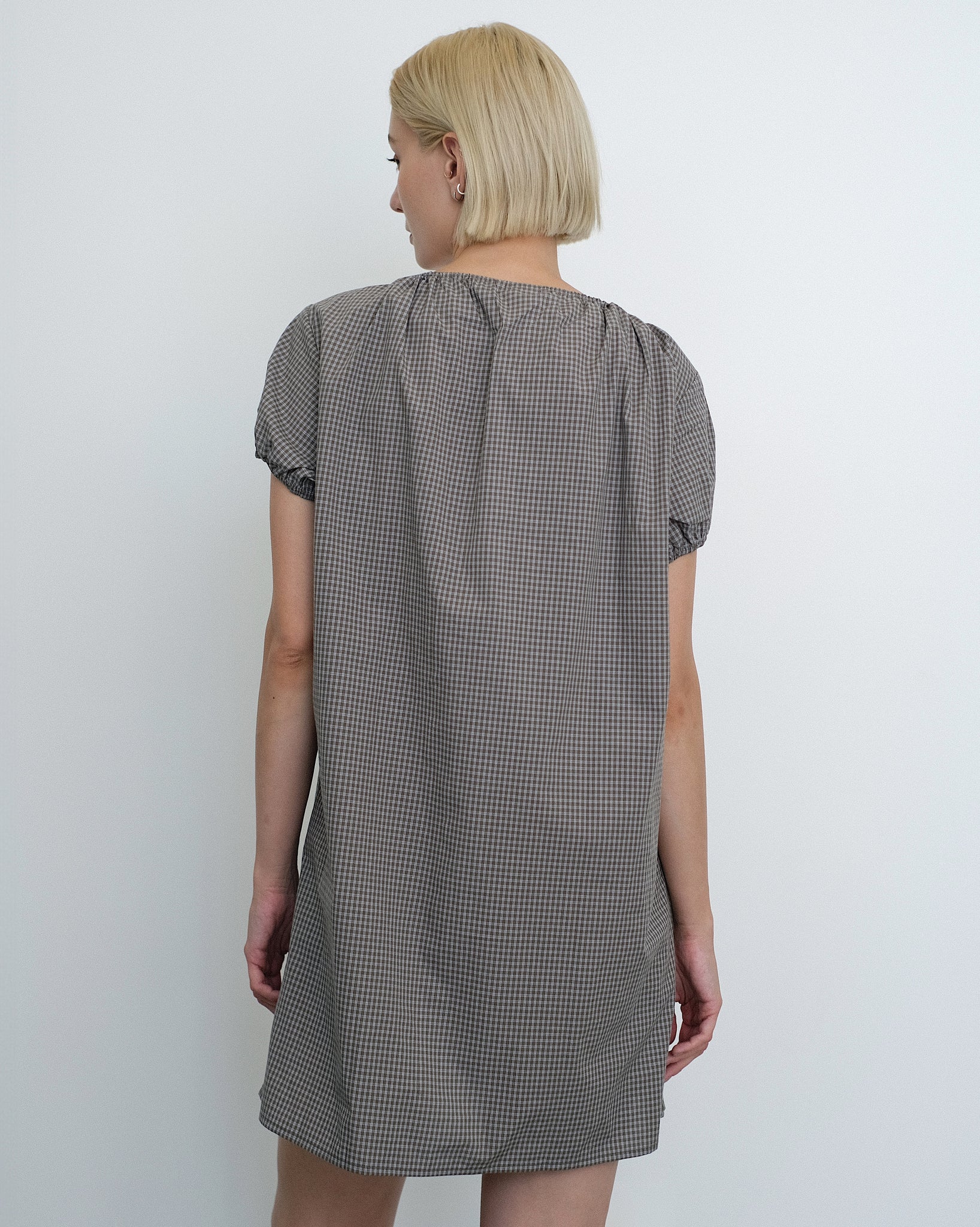 Rear view of Model wearing the Deiji Studios Capped Sleeve Mini Dress in Khaki Check Cotton Poplin