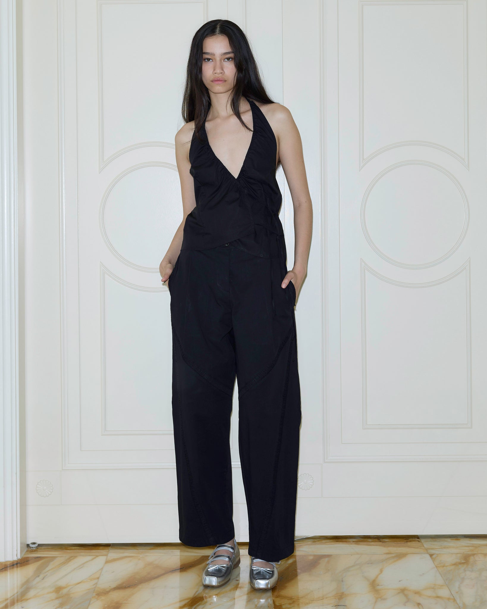 Model wearing the Deiji Channel Pant in Black Cotton Twill 