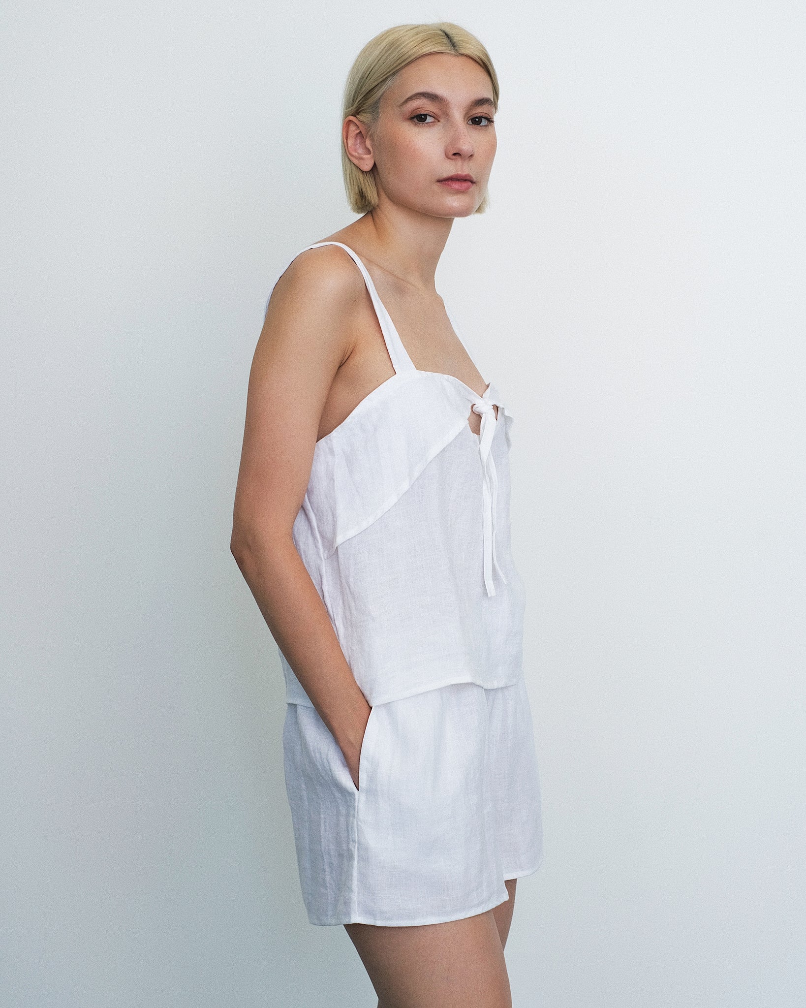 Model wearing the Deiji Studios Tie Front Set in White Linen