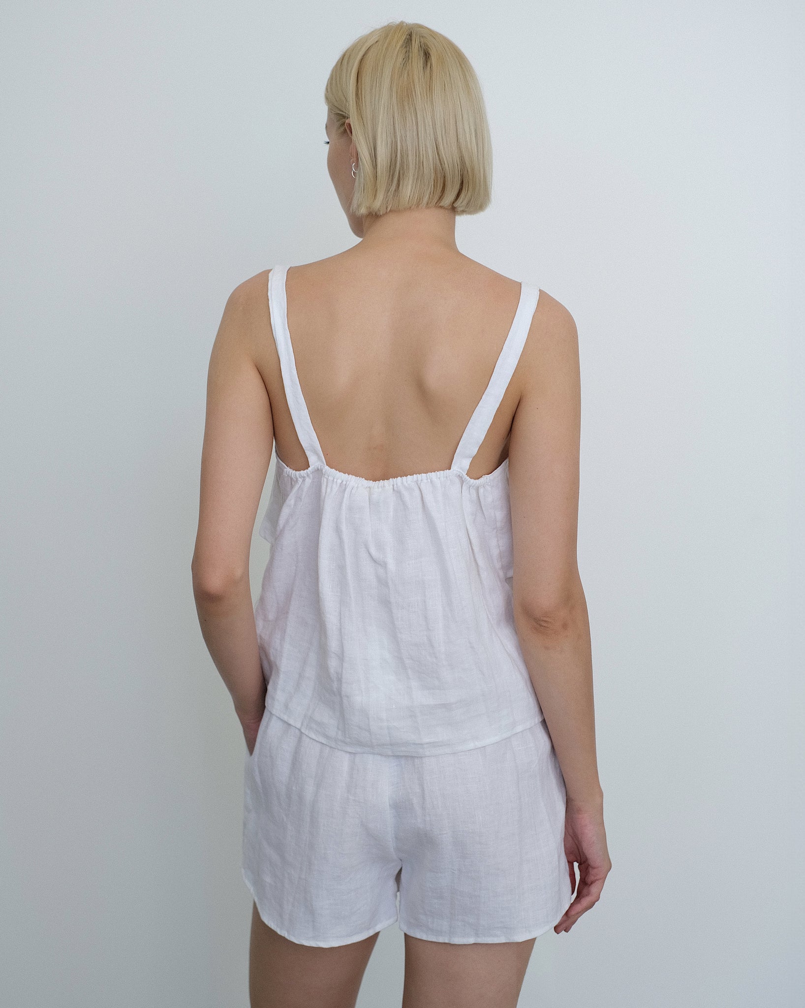 Rear view of model wearing the Deiji Studios Tie Front Set in White Linen