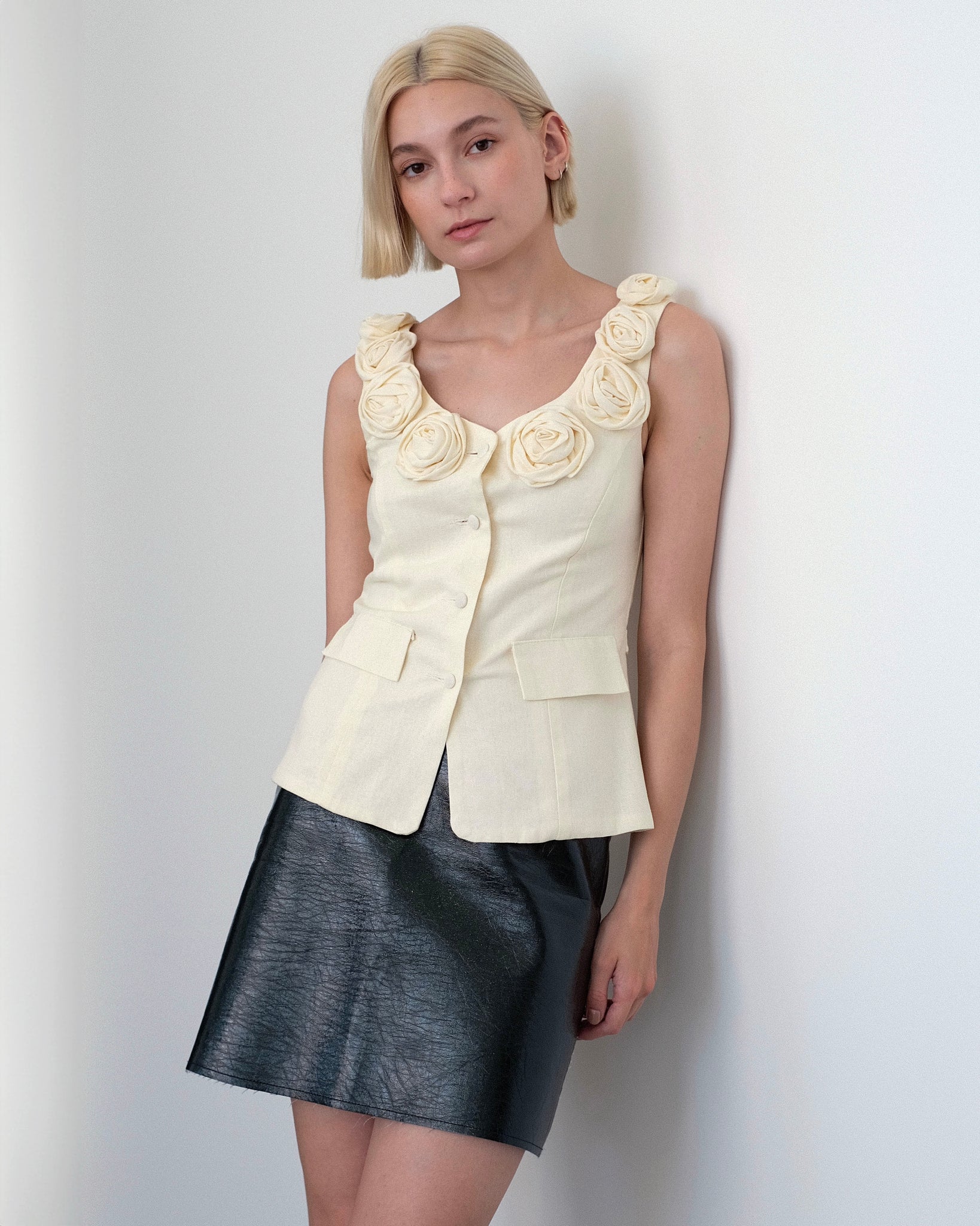 Model wearing the Loire vest top in ivory linen with floral embellished collar from Tach